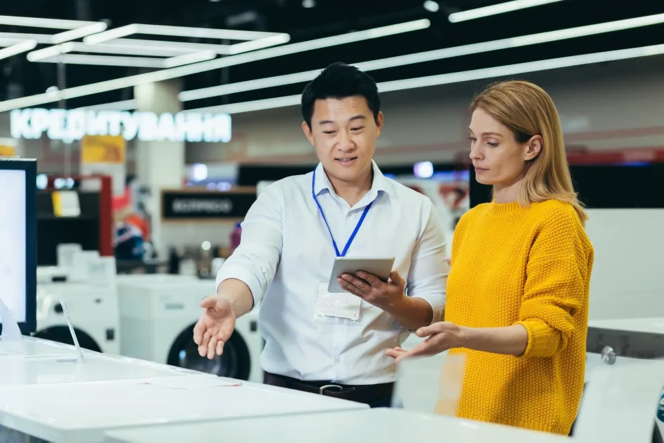 Consultant showing products to a customer in a showroom