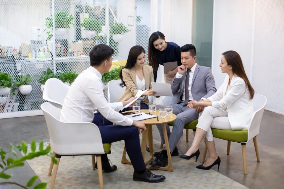 Chinese business team meeting in a bright office