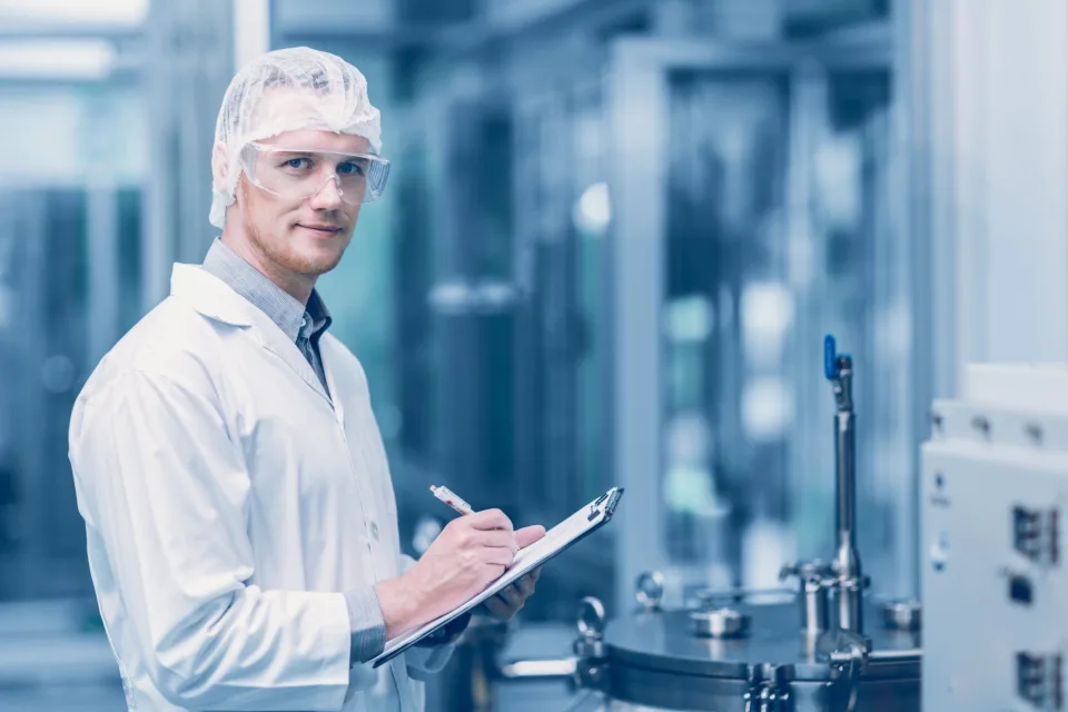 Quality specialist with a clipboard in a production laboratory