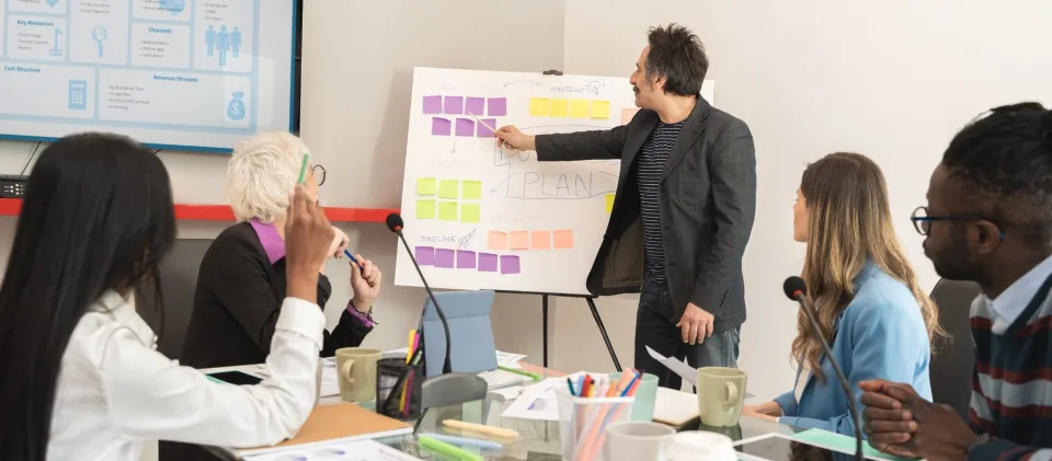 Team planning a brand strategy on a board of sticky notes