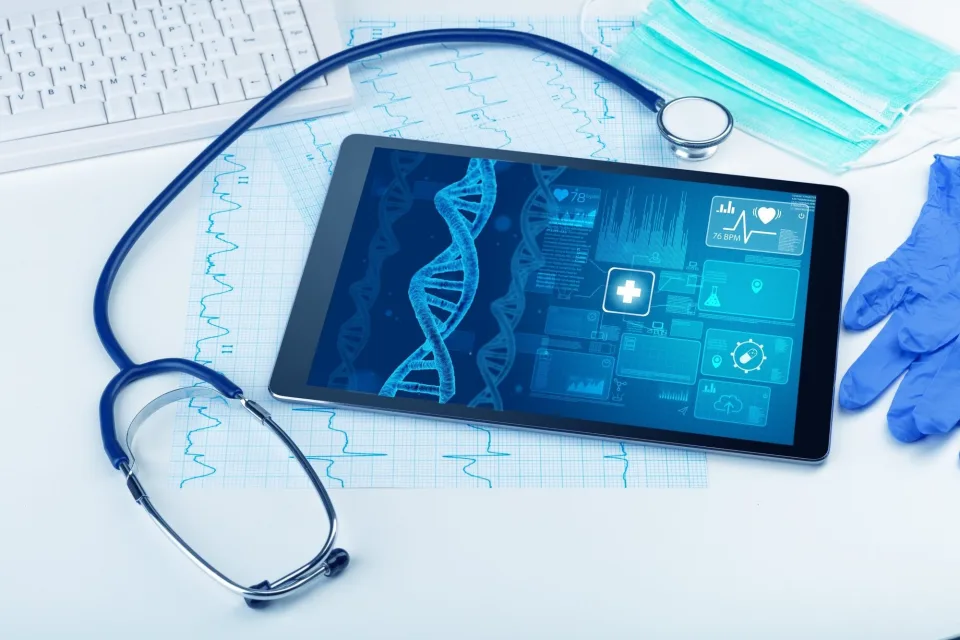 Tablet showing a DNA graphic beside a stethoscope