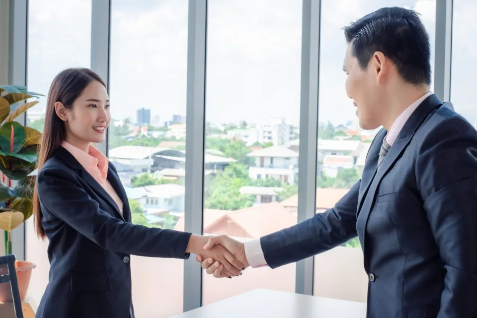 Business partners shaking hands in a modern office